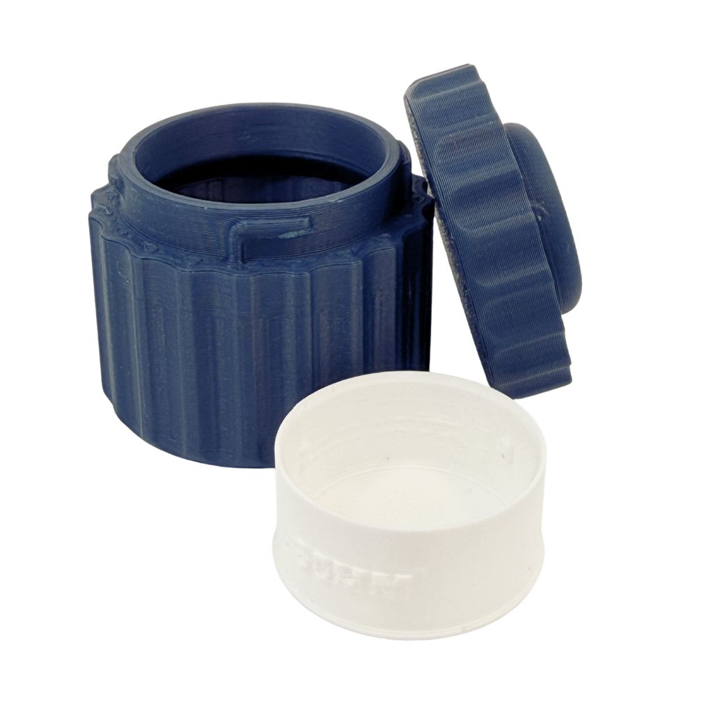 TwistLock metal clay canister with removable lid shown open and closed on a light wood work surface