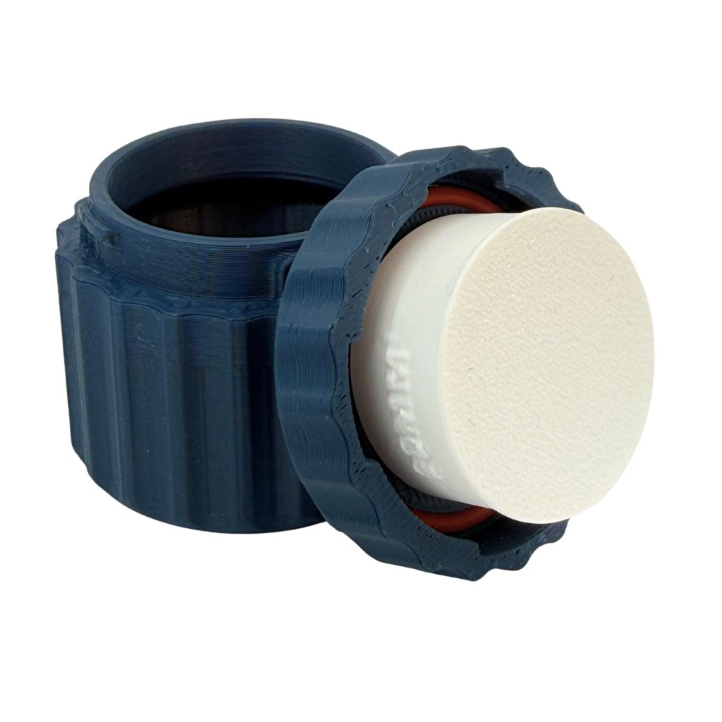 TwistLock metal clay canister with removable lid shown open and closed on a light wood work surface