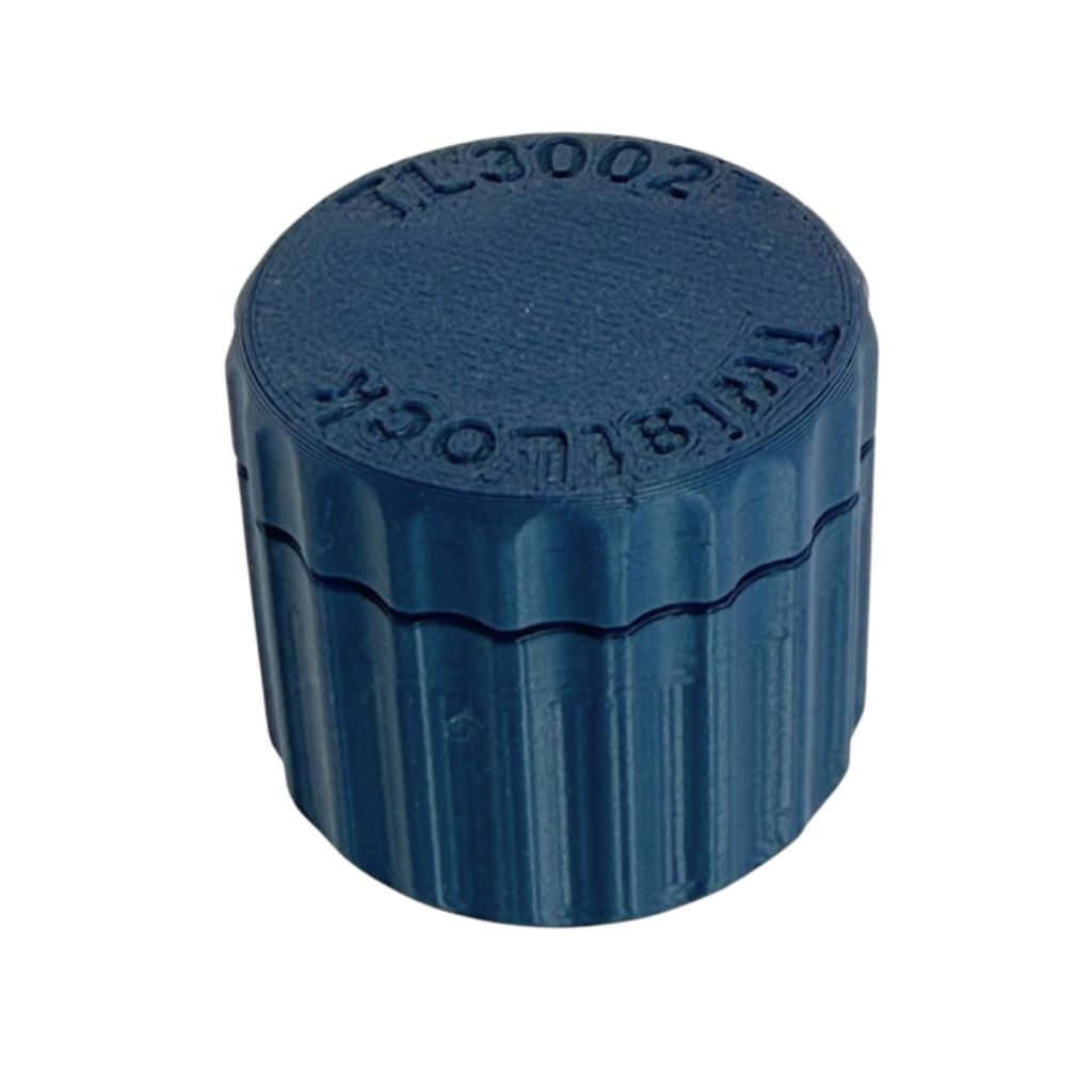 TwistLock metal clay canister with removable lid shown open and closed on a light wood work surface