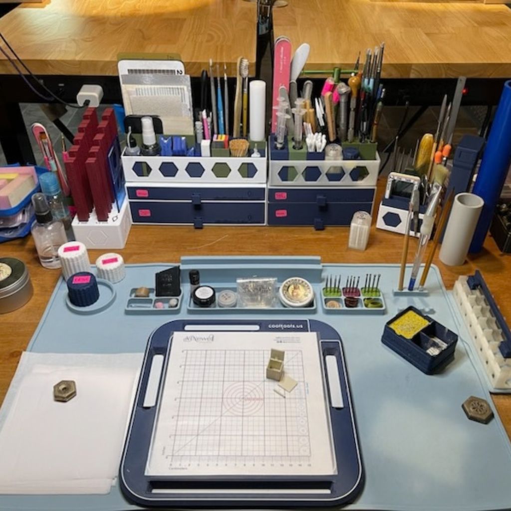 AJ Newell’s metal clay workbench with SlipFit organizers holding tools around a central work surface